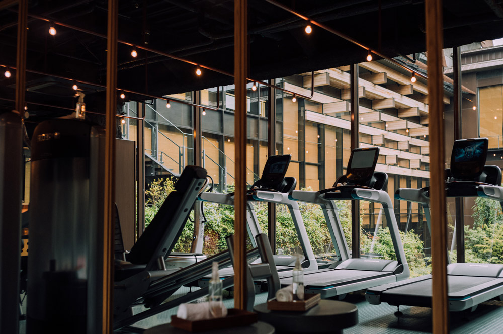 a photo of a gym with equipment that includes treadmills.
