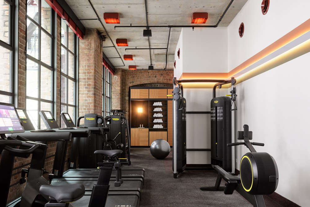 a photo of a gym with equipment that includes treadmills, bike machines, rowing machine and an exercise ball.